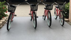 Three bicycles parked in a row on a concrete surface. - Windward Passage Resort (Fort Myers Beach)