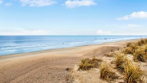 A beach with a clear sky and ocean waves.