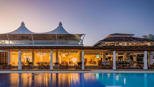 A hotel with a swimming pool, covered outdoor seating, and a large canopy structure. - Ocean View w Pool Roble Sabana in Reserva Conchal (Reserva Conchal)