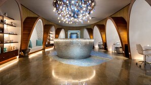 A spacious lobby with a central seating area, wooden arches, and a chandelier. - Ocean View w Pool Roble Sabana in Reserva Conchal (Reserva Conchal)