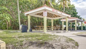 A park pavilion with picnic tables and a trash bin. - Steps to Pompano Beach: Couple's Retreat w/ Patio! (Pompano Beach)