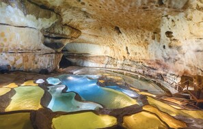 A cave interior with stalactites and a pool of mineral water. - Amazing home in Lussan (Lussan)