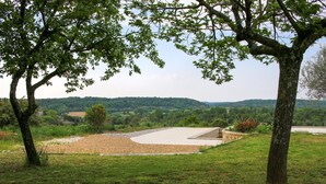 A park with a concrete structure, grassy areas, and trees. - Amazing home in Lussan (Lussan)