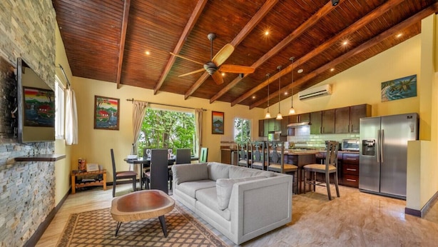 A spacious living area with a sofa, a wooden coffee table, and a patterned rug. - Serene Mar Azul Zen Villa w/ Pool & Yoga Platform (Huacas)