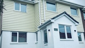 A two-story residential building with a small attached garage.
