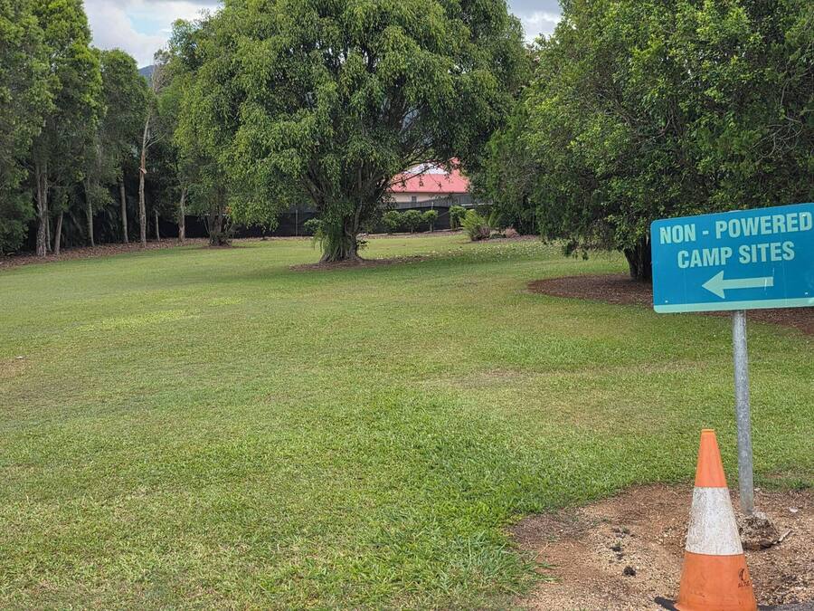 A grassy area with a sign for non-powered camp sites.