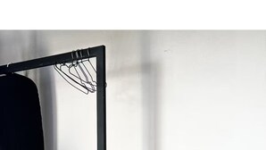 A minimalist room with a black metal desk, a wooden stool, and a black fan. - Upscale 2BR/2BA Apartment with Incredible Mountain Views (Oaxaca de Juárez)