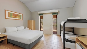 A bedroom with a bed, a bunk bed, a nightstand, a wardrobe, and a door leading to an outdoor area. - Outback Lodge (Ayers Rock)