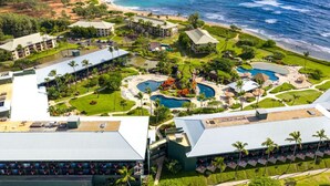 A resort with multiple buildings, a central pool area, and a beach. - Just Listed! Oceanfront Paradise Views and Luxury (Lihue)