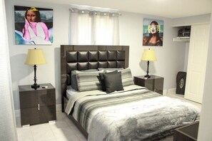 A bedroom with a bed, two bedside tables, and a nightstand. - Perfect 3-bedroom house with AC in lovely Tampa (Tampa)