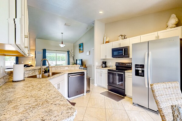 A modern kitchen with granite countertops, stainless steel appliances, and a dishwasher. - Family-Friendly Sebastian Escape — Screened Private Pool, BBQ Grill & Outdoor Patio! 🌴 (Sebastian)