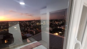 A balcony with a city view at dusk. - Mirador del Cielo  (Santa Cruz)