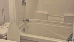 A bathroom with a bathtub, toilet, and sink. - Cozy Private One-Bedroom Suite With Separate Entrance—Dining set & kitchen (Dieppe)