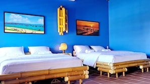 A room with two beds, blue walls, and artwork depicting a beach and sunset. - PHO Homestay Fishing Village  (Mui Ne)