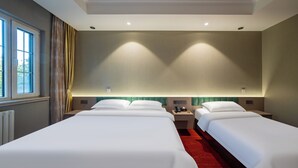 A hotel room with two beds, a window, and a red carpet. - world hotel qing dao zhan qiao  (Qingdao)