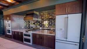 A modern kitchen with stainless steel appliances, a marble countertop, and a backsplash of reflective tiles. - Funky 1 Bedroom in 5 Points. State of the Art Gym. Long Term Stays Welcome (Birmingham)