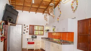 A compact kitchen with white cabinets, a stainless steel sink, and a tiled floor. - Family cabin in Punta Bolivar, safe condominium near the sea, with parking. (San Antero)