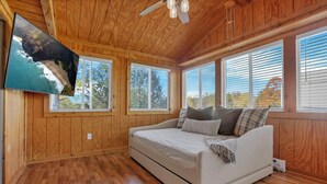 A bedroom with a wooden ceiling, a bed, and large windows. - The Nook on the Farm—Pool • Hot Tub • Games (Pataskala)