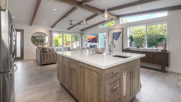 A spacious kitchen with a large island, wooden cabinets, and a modern pendant light. - Luxury 3-Bed Beach Cottage with Hot Tub, Fire Pit, BBQ - Walk To Beach (Cardiff By The Sea)
