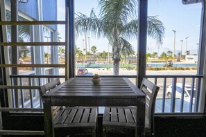 Outdoor dining - Updated 2-Level Madeira Beach Yacht Club Condo – Porch, Pool Access & Walk to the Beach (Madeira Beach)