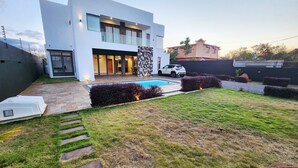 A modern two-story house with a swimming pool, stone steps, and well-maintained hedges. - Tropical Elegance Haven - 4 bedrooms Villa on Mauritius’ Northwest Coast (Tombeau Bay)