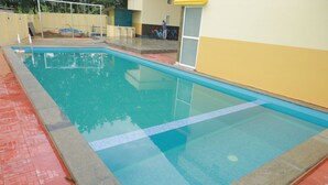 A swimming pool with a tiled edge and a red floor. - Kpp Resort (Kalkulam)