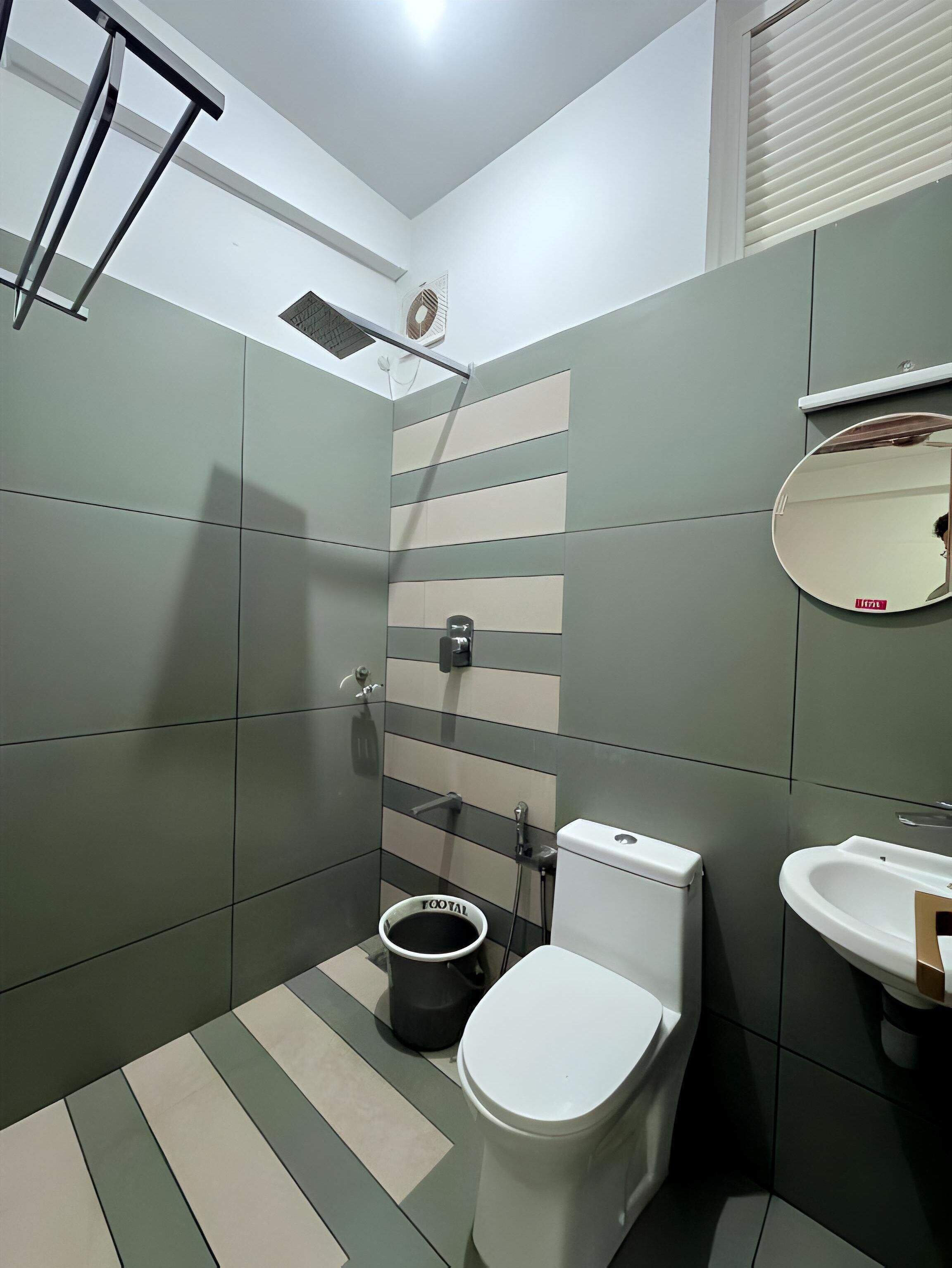 Une salle de bain moderne équipée de toilettes, d’un bidet et d’un lavabo.