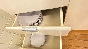 A drawer with stacked plates. - AkiraHome Tsutenkaku West (Osaka)