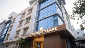 A multi-story building with a sign reading 'HOTEL SAI SEETA PALACE.'