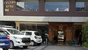 A building with a sign reading "CEYLON BAK HOUSE". There are parked cars in front. - Ceylon Bake House Woodland Junction (Kanayannur)