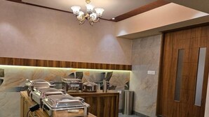 A buffet area with a wooden counter and food dispensers. - Ceylon Bake House Woodland Junction (Kanayannur)