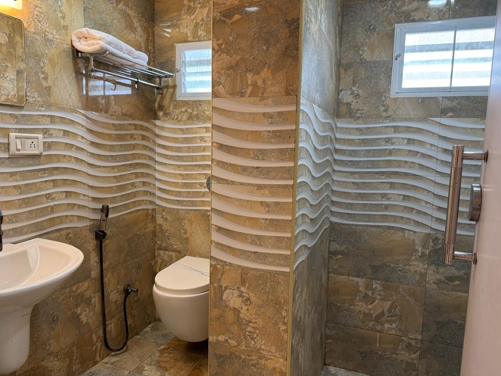 A bathroom with a sink, toilet, and shower area.