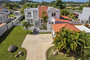 A modern residential complex with multiple buildings, a central courtyard, and surrounding greenery. - Enchanted Hideaway with Private Pool (Puerto Rico)