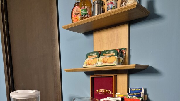 A breakfast bar with croissants, Nutella, and various breakfast items.