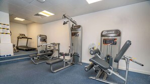 A gym with various exercise equipment including treadmills, weight machines, and a bench press. - Budget Bright En-Suite Room in Central Coventry (Coventry)