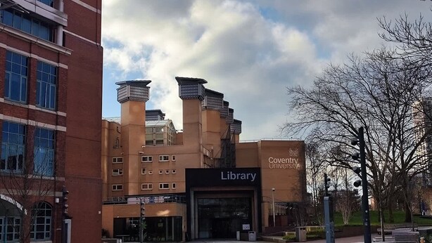 A building with a prominent library entrance, surrounded by modern architecture and a clear sky. - 2 Budget En-Suite Rooms with Shared Kitchen (Coventry)