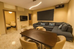 Suíte família, vista para a colina | Área de estar | Smart TV 59 polegadas com canais a cabo