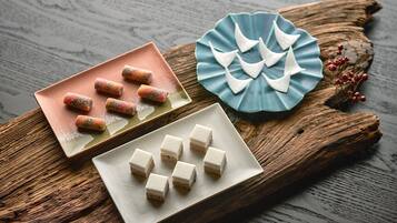 A wooden table with three plates of food.