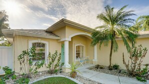 A single-story house with a beige exterior, a covered patio, and a palm tree. - Family Haven w/ Pool! 8 Mi to Warm Mineral Springs (North Port)