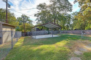 A fenced backyard with a covered patio area, a wooden fence, and a utility pole. - < 1 Mi to Dtwn Texarkana: Couple's Retreat w/ Yard (Texarkana)
