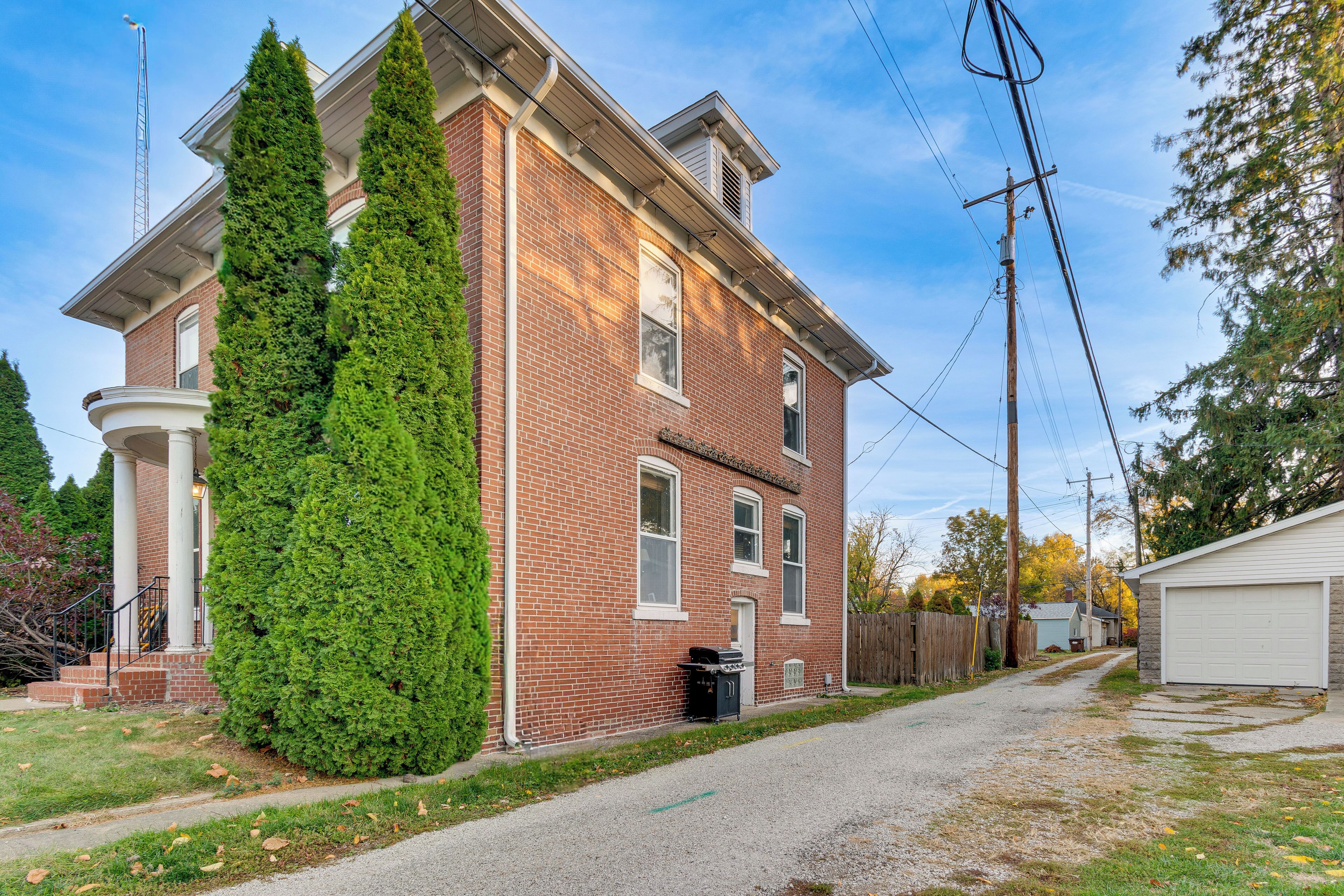 Un bâtiment en briques de deux étages, doté d’un porche couvert et d’un garage.