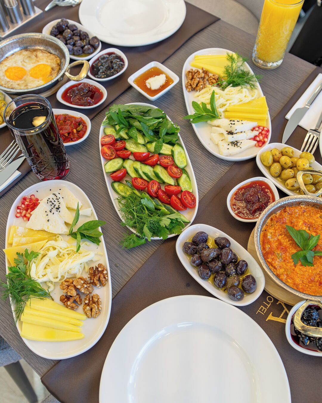 A table set with various dishes including eggs, vegetables, and olives.