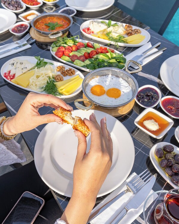 A table with various dishes including eggs, salad, and cheese, suggesting a breakfast setting. - ROSSA MARIN HOTEL (Darica)