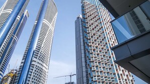 Two high-rise buildings with modern architecture, one with a curved facade and the other with a grid-like pattern. - Stayshort - 1 Bed in Business Bay Sleeps 2 With City Views (Dubai)