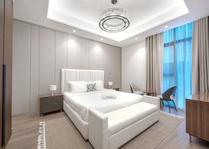 A modern hotel bedroom with a large bed, bedside tables, a desk, and a chair. - Stayshort - 1 Bed in Business Bay Sleeps 2 With City Views (Dubai)
