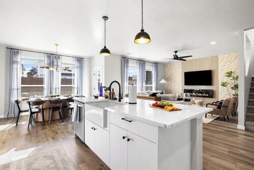 This 5-bedroom home has it all—gas fire pit for 8, hot tub, cornhole, ladder golf, ping pong, and a gas grill. Inside, enjoy a rock climbing wall, office desk, and a garage gym.