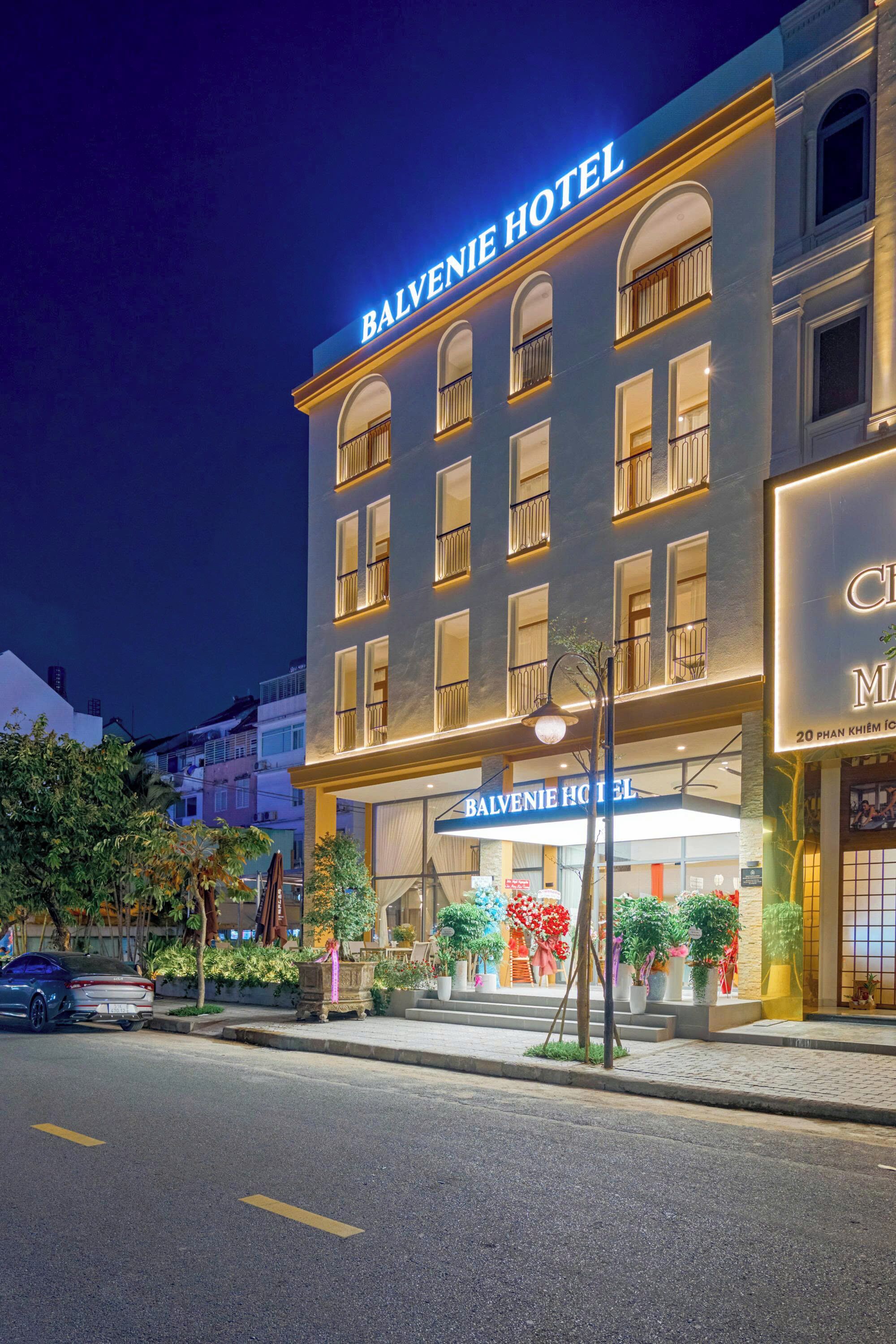 A hotel with a prominent sign reading "BALVENIE HOTEL" and a large entrance with steps leading up to the door.