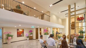 A spacious hotel lobby with a high ceiling, a second-floor balcony, and a reception desk. - BALVENIE HOTEL Phu My Hung SECC (Ho Chi Minh City)