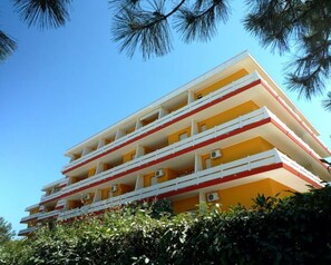A multi-story building with balconies, likely a hotel or apartment complex. - Family Stay With Fenced Garden in Lido dei Pini (San Michele al Tagliamento)
