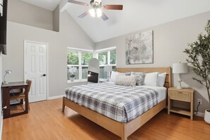A bedroom with a bed, a desk, a chair, a ceiling fan, a TV, a window, and a plant. - 13-minutes drive to Arlington Entertainment district, 17 minutes to DFW airport (Grand Prairie)